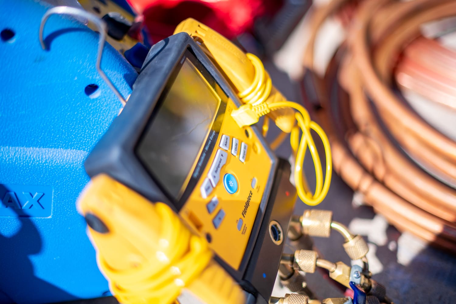 A yellow and black device is sitting on some wires