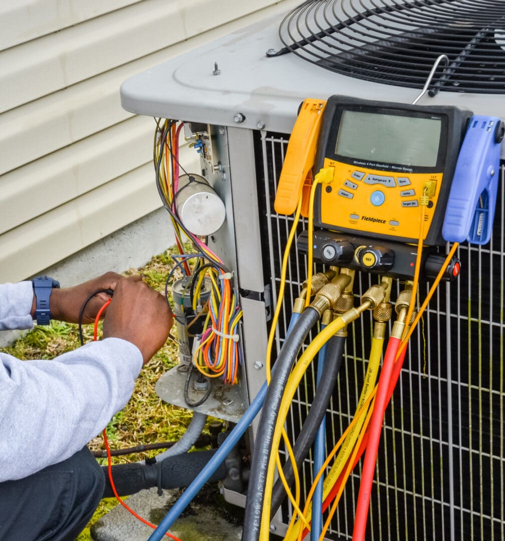 A man working on an air conditioner unit.