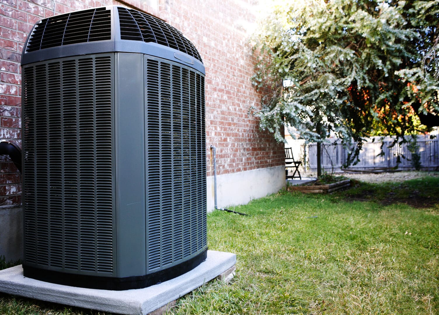 A large air conditioner sitting in the grass.