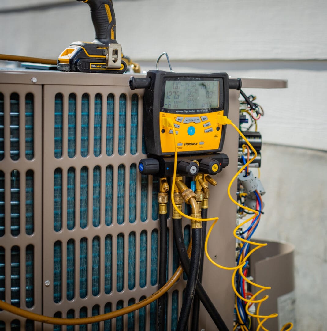 A yellow and black device on top of an air conditioner.