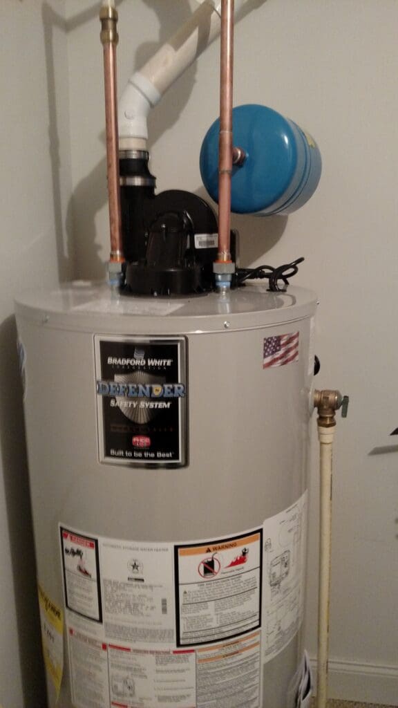 A water heater with pipes and valves on the side.